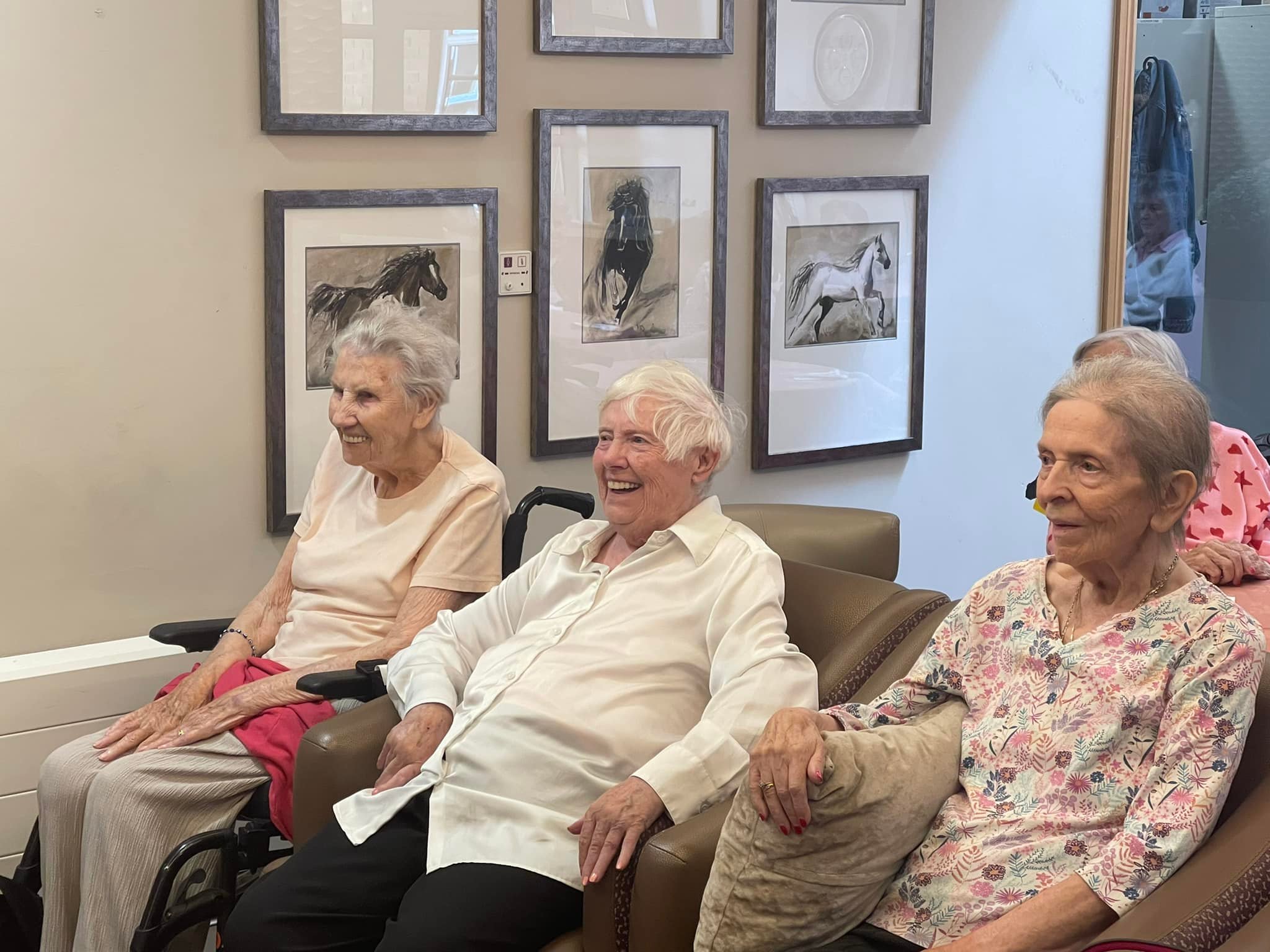 Residents in Armchairs Enjoying Entertainment